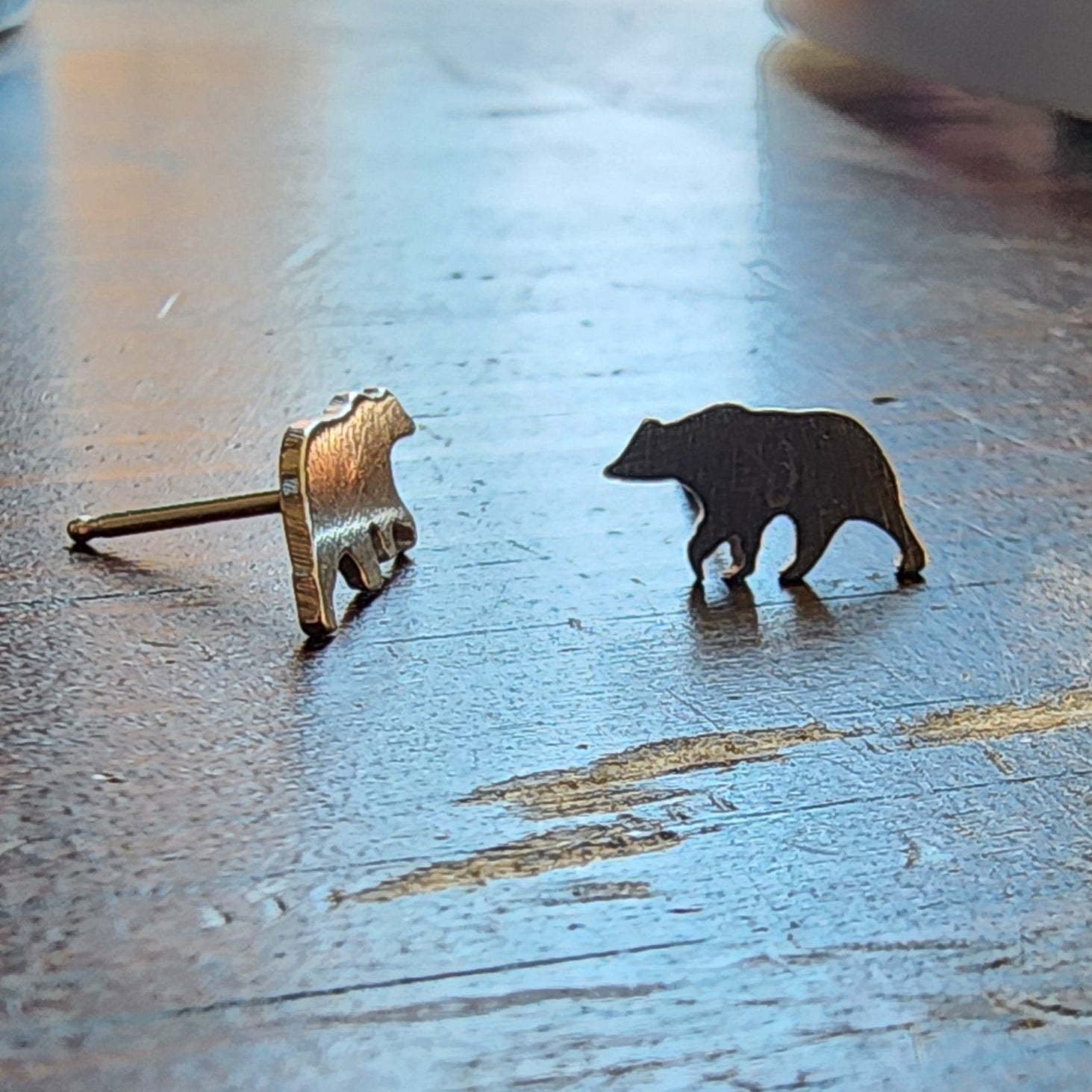 sterling silver bear stud earrings with silicone backs, one straight on and one side view