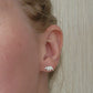 sterling silver bear stud earrings with silicone backs, in left ear with bear facing towards face