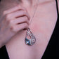 Layered sterling silver and textured seaweed stingray pendant and silvery blue amazonite doublet closeup